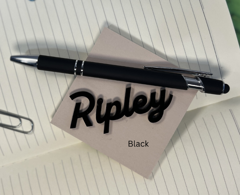 Black pen on a piece of paper with 'Ripley' written on it, placed on a notebook. From She Shed Designs