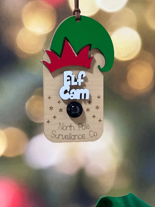 Decorative tag with a elf design on a blurred Christmas tree background