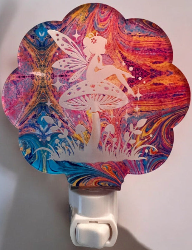 Handcrafted acrylic nightlight featuring a fairy with a mushroom design in a Pink and blue paint pour. From She Shed Designs.