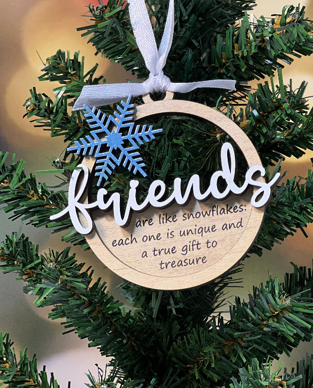 Christmas ornament with 'friends are like snowflakes: each one is unique and a true gift to treasure' snowflake design on a tree From She Shed Designs