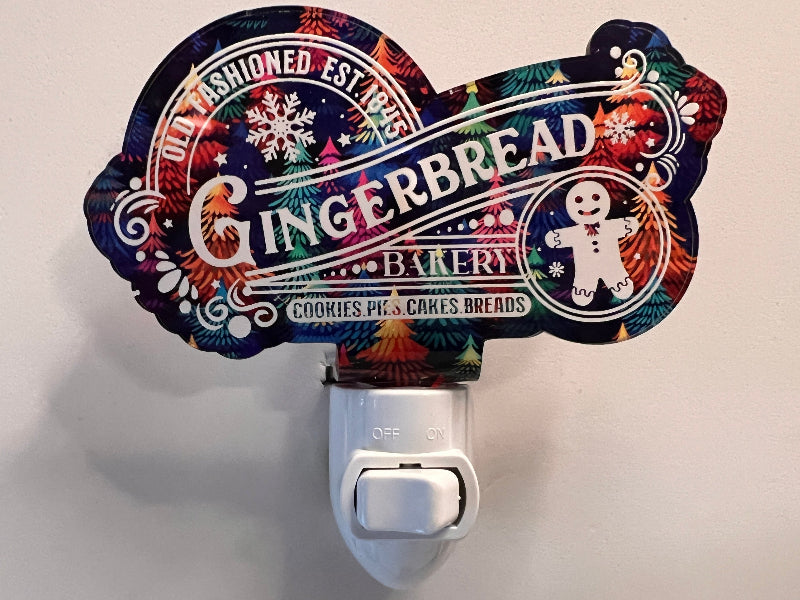 Handcrafted acrylic nightlight with a gingerbread bakery theme, featuring an engraved design and a LED bulb, on a white background. From She Shed Designs.