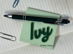 Pen on a green sticky note with 'Ivy' text on lined paper. From She Shed Designs