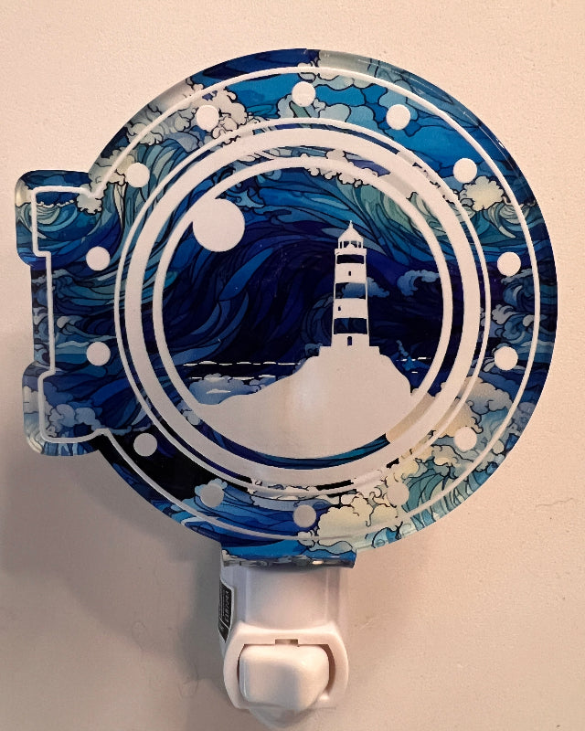 Handcrafted acrylic nightlight with a lighthouse design in blue, white, and black colors. From She Shed Design.
