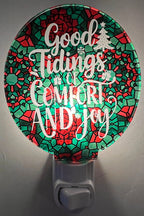 Handcrafted acrylic nightlight with a festive 'Good Tidings of Comfort and Joy' message, featuring red and green colors and a tree. From She Shed Designs.