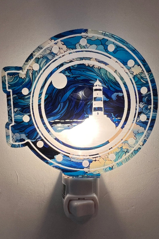 Handcrafted acrylic nightlight with a lighthouse design in blue, white, and black colors. From She Shed Design.