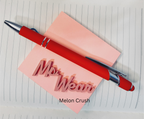 Red pen with silver clip on a pink notepad labeled 'Mrs. Wear' on lined paper.