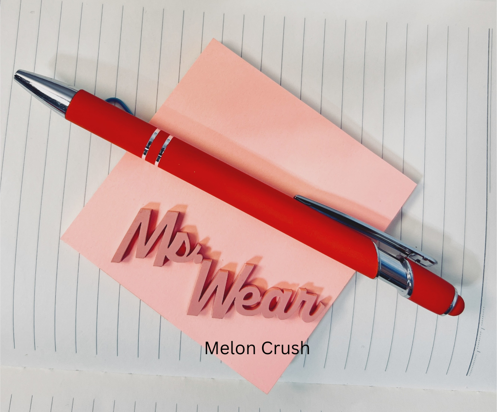 Red pen with silver clip on a pink notepad labeled 'Mrs. Wear' on lined paper.