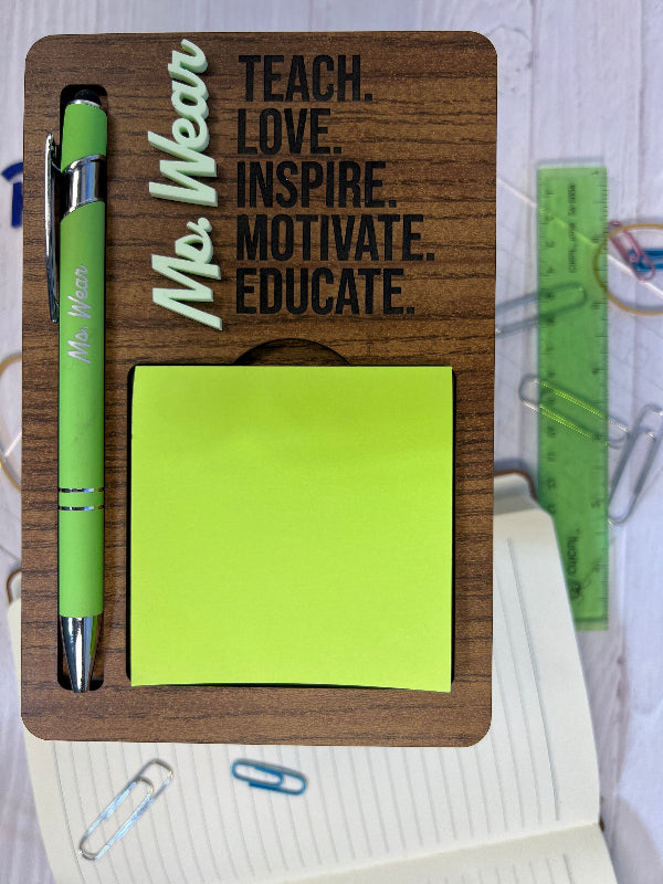 Wooden desk organizer with a pen, sticky notes, and stationery items on a desk.