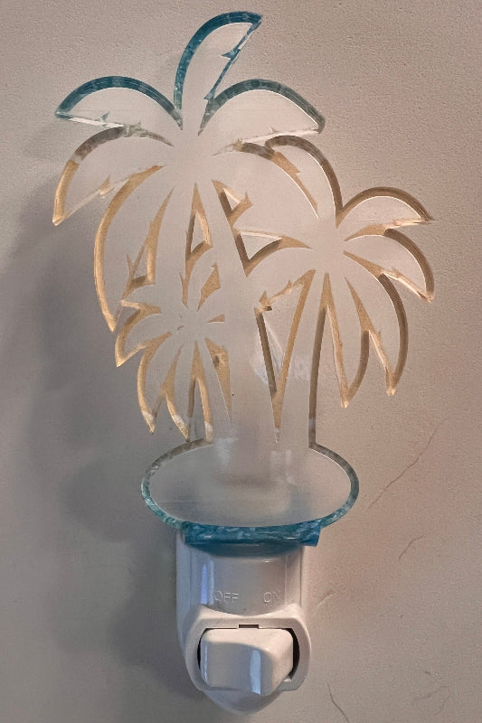 Handcrafted acrylic nightlight with a palm tree design, mounted on a wall. From She Shed Designs.