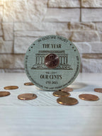 Circular Magnet with penny on linen patterned wood. From She Shed Designs