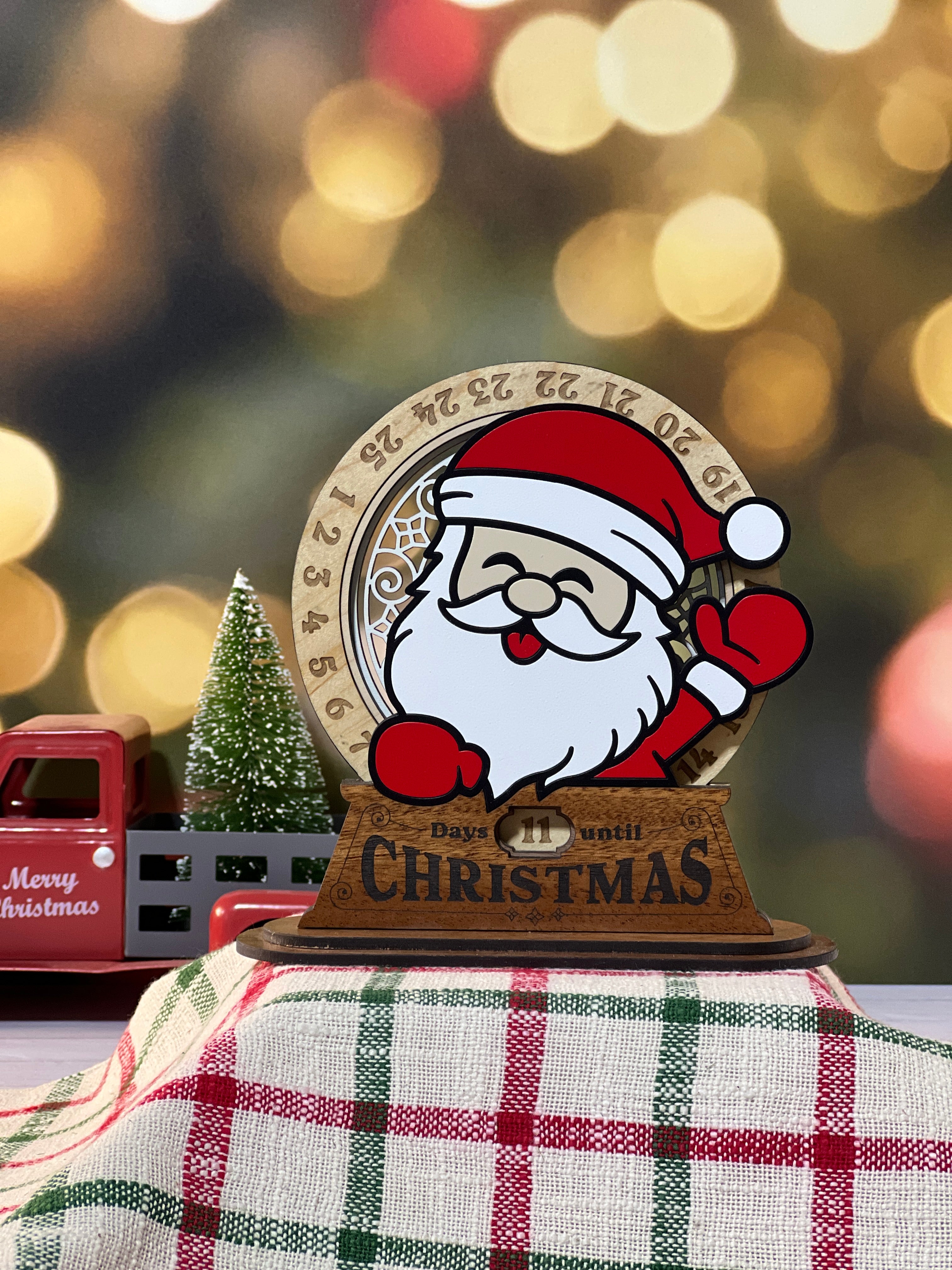 Christmas-themed Advent calendar stand with Santa Claus design on a festive background. From She Shed Designs