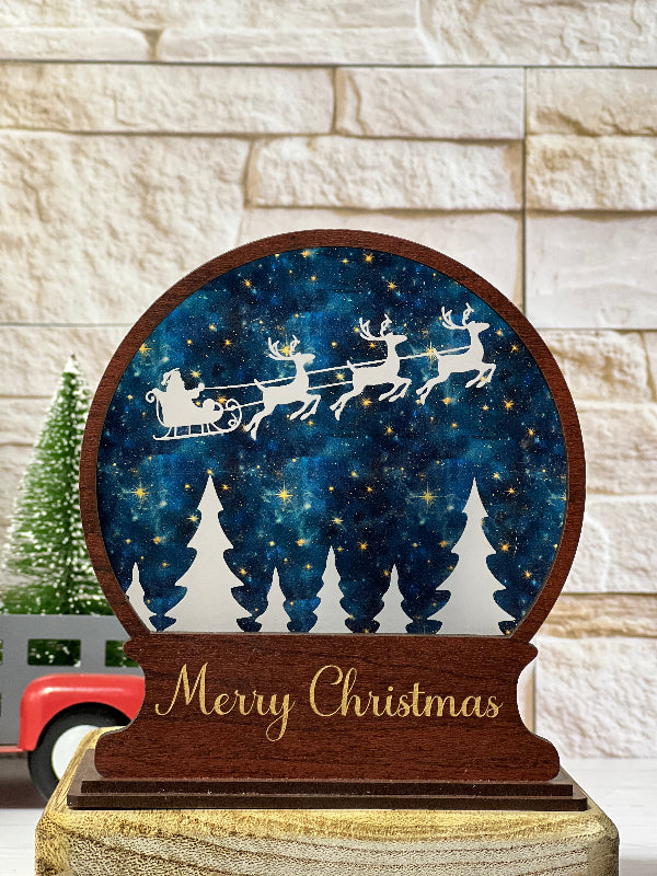 Decorative Christmas sign with Santa's Sleigh and tree design on a wooden frame. From She Shed Designs