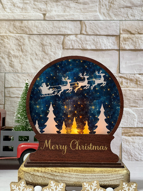 Wooden Christmas decoration with reindeer sleigh and 'Merry Christmas' text on a stone wall background. From She Shed Designs