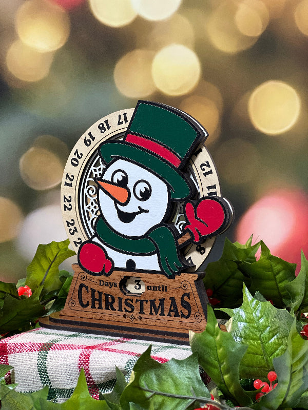 Christmas-themed Advent calendar stand with a Snowman design on a festive background. From She Shed Designs