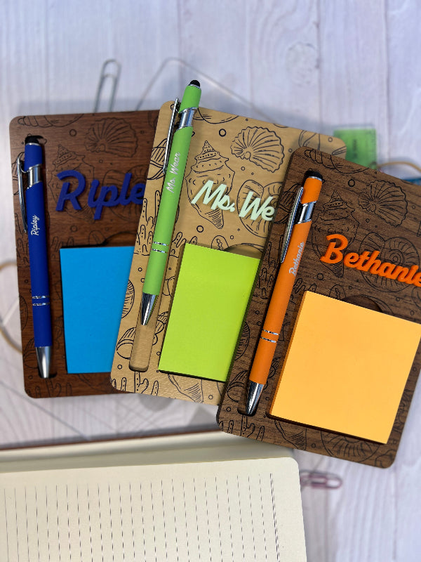 Personalized notepad holder and pen set with sticky notes. From She Shed Designs