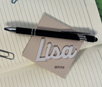 Black pen on a piece of paper with 'Lisa' written on it, placed on a lined notebook. From She Shed Designs
