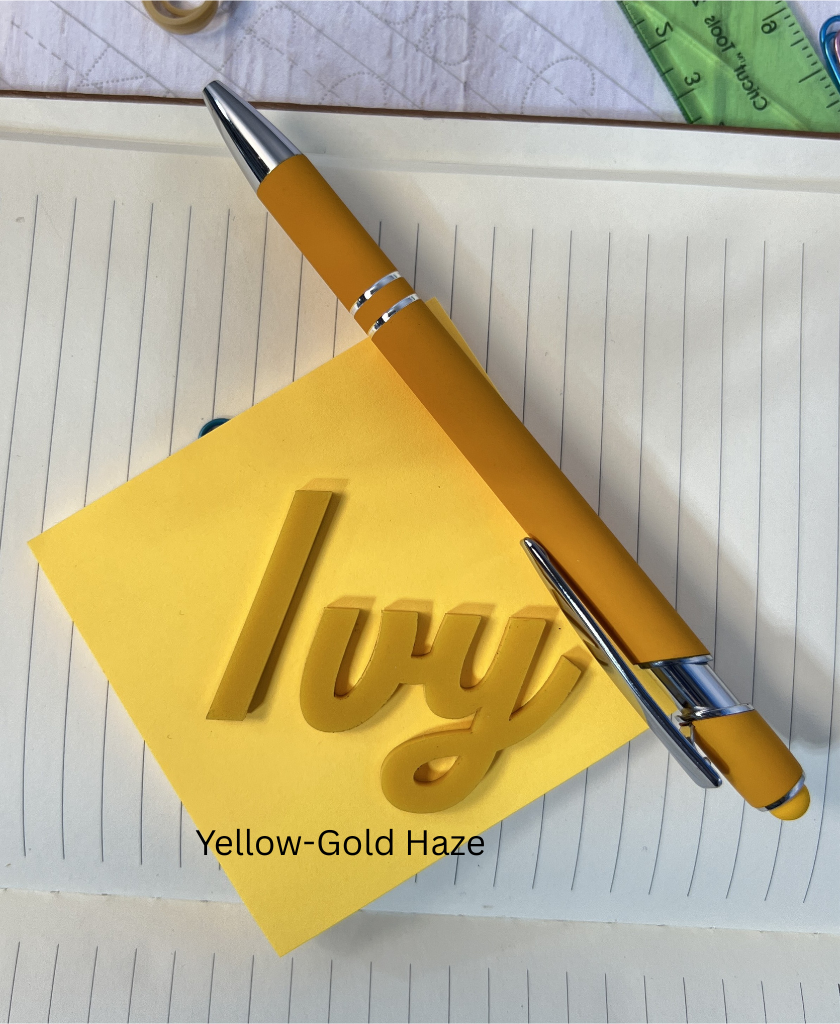 Yellow pen and sticky note with 'Ivy' on a notebook page