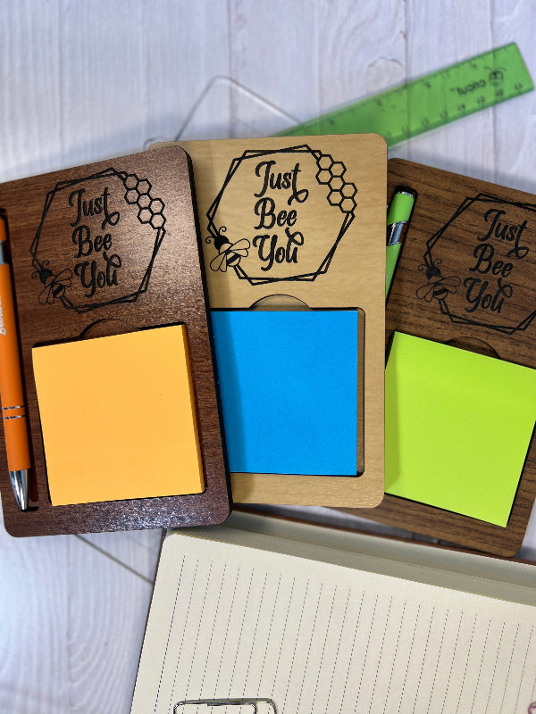 Wooden desk organizer with colorful sticky notes and a pen, featuring 'Just Bee You' text.